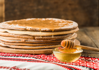 baked honey cakes for the cake in a pile on a wooden  background.