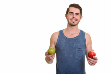 Portrait of happy young handsome bearded man ready for gym