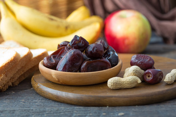 dates  in a bowl with fruit and nut. Planning of a diet. Detox, healthy eating and vegetarian diet concept. Balanced fuits diet. Healthy lifestyle tips.