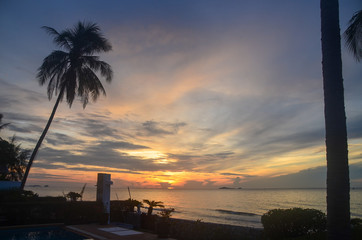 Tropical sunrise seascape with Palm trees, Thailand.
