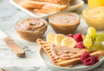 Homemade toast bread with jam and variety peanut almond  butter on wood table for breakfast. Delicious toast bread ready to served.