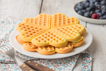 Sweet Belgium waffles hearts with coconut. Chocolate Belgium waffles