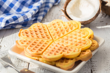 Sweet Belgium waffles hearts with coconut. Chocolate Belgium waffles