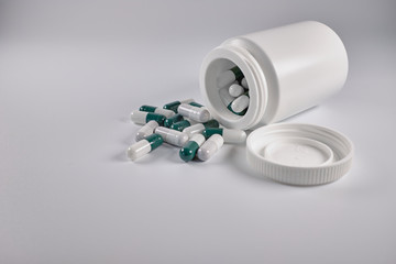 pills and bottle on white background