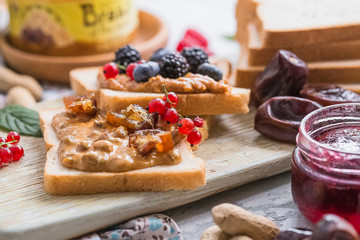 Belgium waffles heart with chocolate sauce raspberries on wood background.