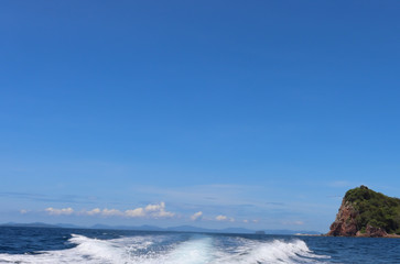 boat ride on the sea, exotic James Bond islands against the blue sea, waves of spray in Thailand