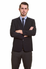 Portrait of young handsome bearded businessman in suit
