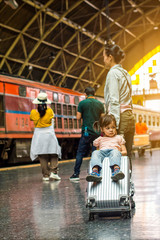 Child and mother travel by train.