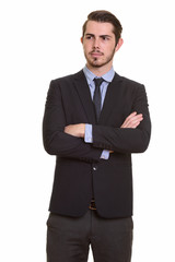 Portrait of young handsome bearded businessman in suit