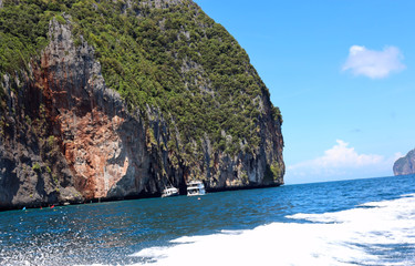 boat ride on the sea, exotic James Bond islands against the blue sea, waves of spray in Thailand