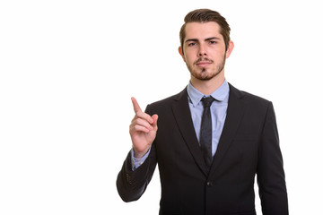 Portrait of young handsome bearded businessman in suit