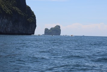 boat ride on the sea, exotic James Bond islands against the blue sea, waves of spray in Thailand