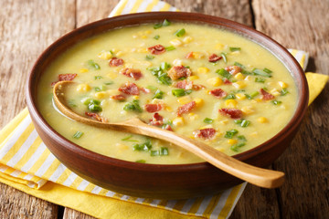 Delicious vegetable corn chowder with bacon close-up in a bowl. horizontal