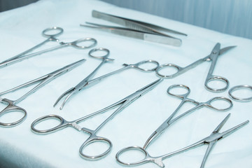 Stainless steel surgical scissors on the operating table. Medical instruments for surgery close-up.