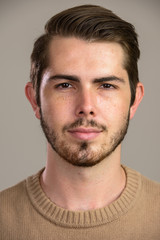 Fototapeta premium Face of young handsome bearded man looking at camera