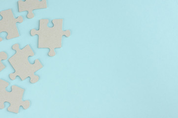 Gray puzzles composition on blue background. Flat lay