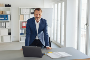 Smiling smart professional businessman in office