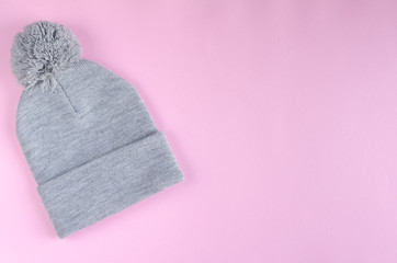 Gray cotton hat composition on pink background. Flat lay.