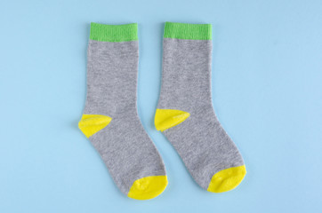 Kids socks composition on blue background. Flat lay.