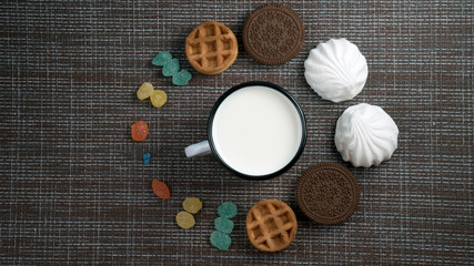 clock made of sweets and milk on the table flatlay
