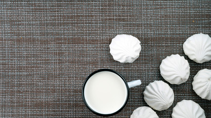 marshmallows and a mug with milk on the table flatlay