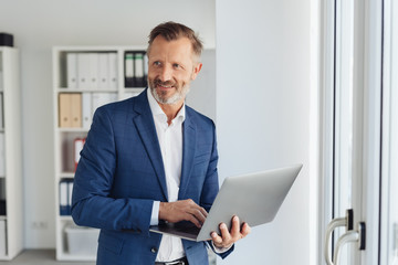 Smart businessman using a handheld laptop computer