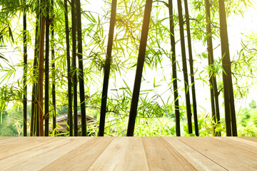 Empty top wooden table on bamboo tree green nature background concept