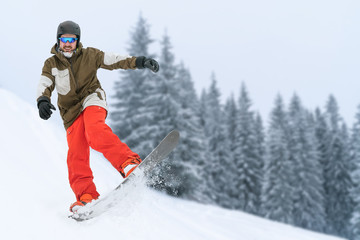 Fototapeta na wymiar Snowboarder on snow hill. Mountain freeride snowboarding. Winter Carpathians