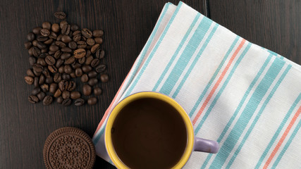 cup of coffee, cookies and coffee beans on background