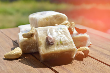 sonpapdi and nuts on wooden table