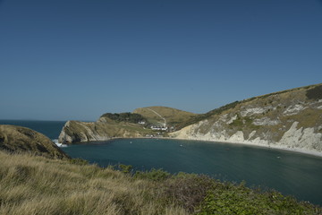 Obraz premium View over Lulworth Cove rock formations and strata on the Dorset coast