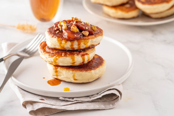 Pancake stacked with maple syrup and apple fruit. Copy space.