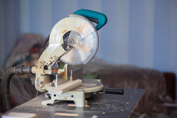 A circular saw on a workbench in an apartment. House repair, saw cut wooden products