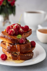 French toasts, French toasts made of sliced brioche with fresh raspberries, honey and mint. Delicious breakfast or dessert