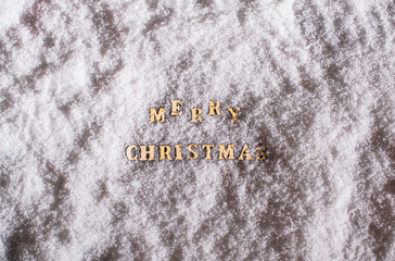 Merry christmas from wooden letters on the night snow. Top view. Winter. Copy space