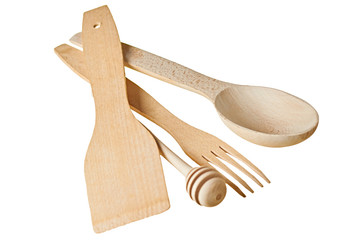 Set of kitchen utensils wooden spoon, ribbed dipper for honey, fork, spatula isolated on white background without shadow. Close-up