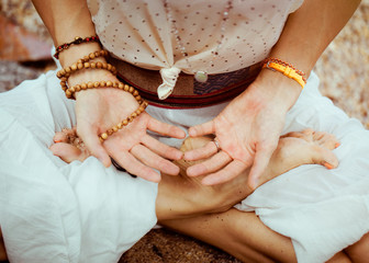 Girl is holding her hands open on her lap  in meditation and Reki  Healing 