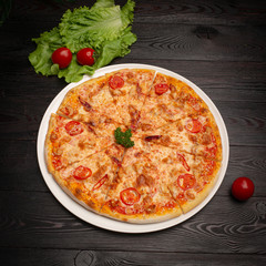 assorted pizza sliced into pieces with cheese, tomato and olives