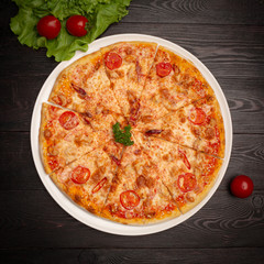 assorted pizza sliced into pieces with cheese, tomato and olives