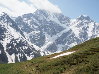 Fototapeta na wymiar Beautiful mountain landscape of Caucasus. View of glacier named Seven. View of mountains Donguz - Orun, Nakra. Landscape with snow peaks, white clouds and green hills