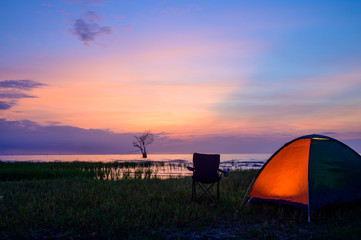Fototapeta na wymiar Tent and chairs by the lake