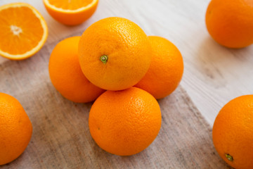Fresh ripe organic oranges on a white wooden surface, low angle view. Close-up.