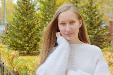 Naklejka premium autumn portrait of blond teenager with green eyes