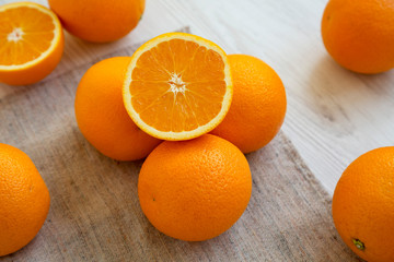 Fresh ripe organic oranges on a white wooden background, side view. Close-up.
