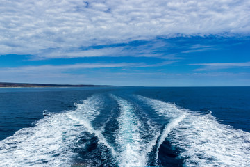 Trail on water surface behind of fast moving motor boat, Western Australia