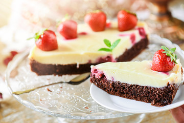 Fresh tart piece with forest fruits like strawberries on top and vanilla cream..Finest cake or dessert selective focus.