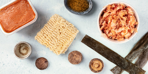 A panorama of ramen ingredients. Dried sea vegetable kelp, soba noodles, miso paste, sake, mirin,...