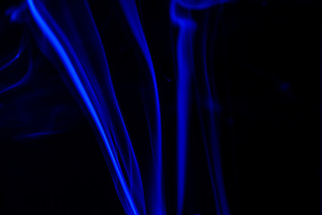 blue smoke from aromatic sticks on a black background - 299487710