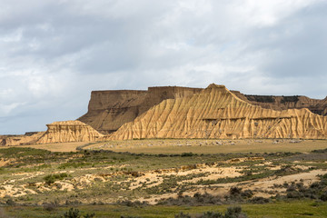 Steep mountain with a shrubby foothill in the badlands Bardenas Reales