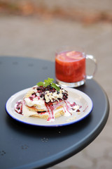 Classic american pancakes with fresh berry and coffee on the table. Pancakes with fruit and berry sauce. Summer homemade breakfast with raspberry tea. Dessert with a pink drink